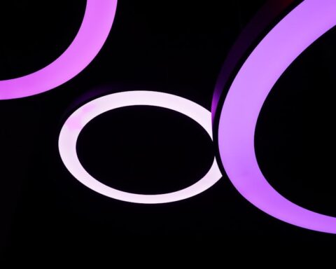 briloner leuchten - Contemporary abstract image of glowing purple LED rings on a black background fo