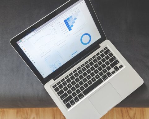 everysize - Overhead view of a laptop showing data visualizations and charts on its screen.