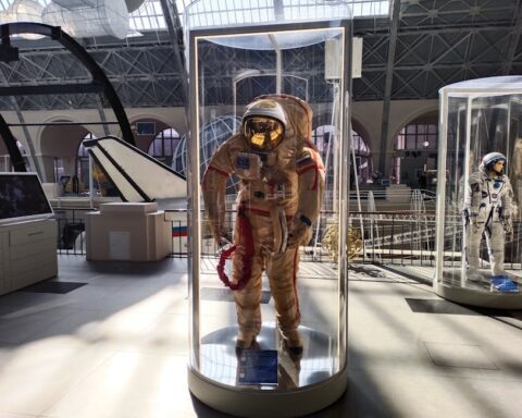 universum bremen - Historic space suits showcased in a museum with ample natural light.